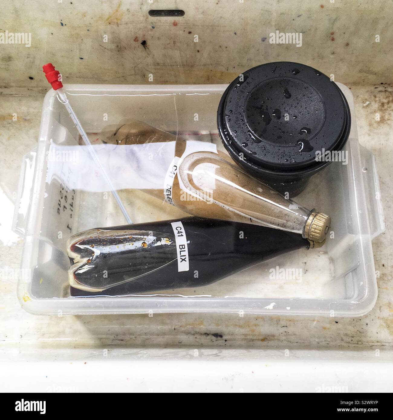 Hand processing c41 colour film. - Smartphone Captured Stock Image