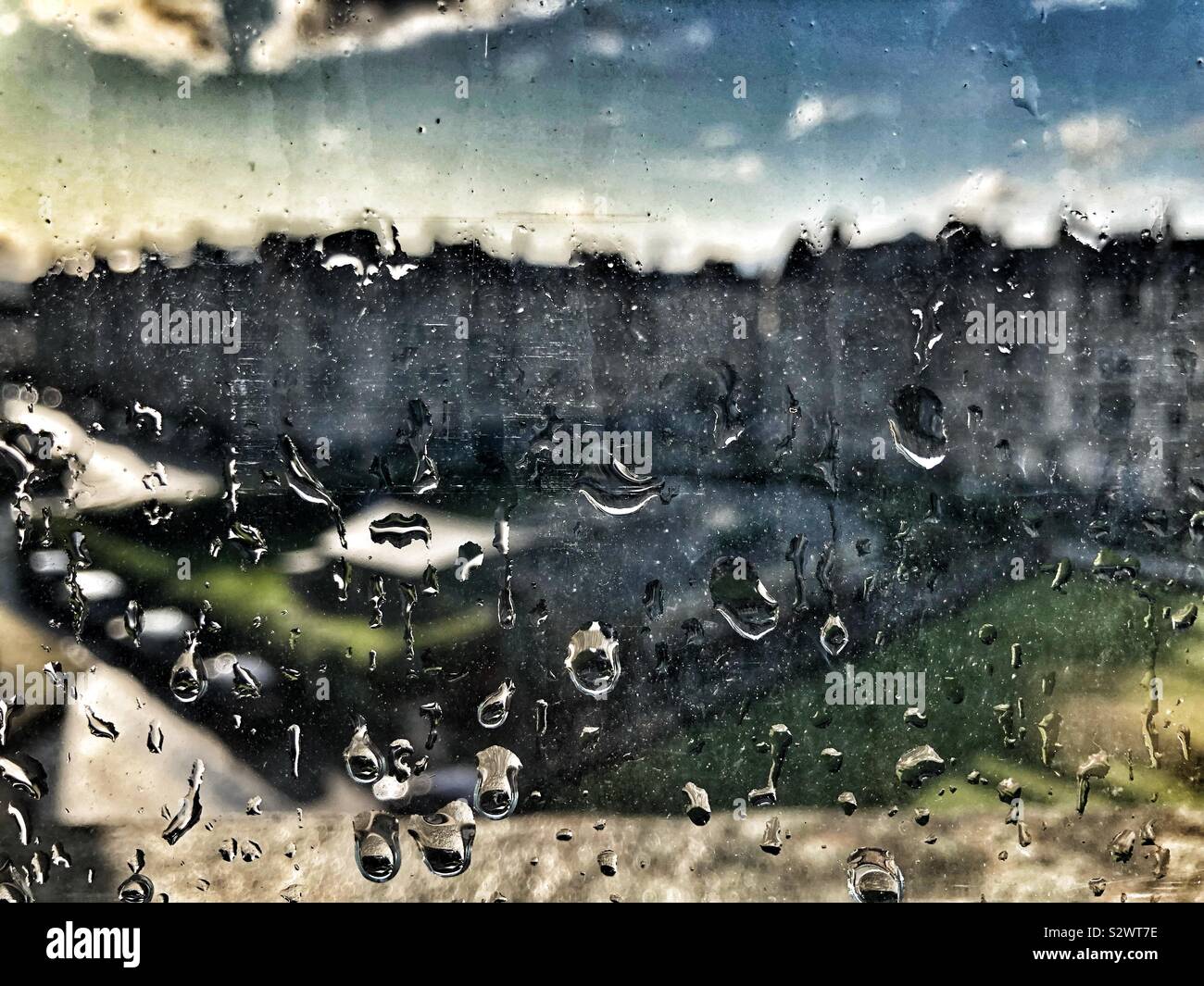 Raindrops on window with evening sun - Smartphone Captured Stock Image