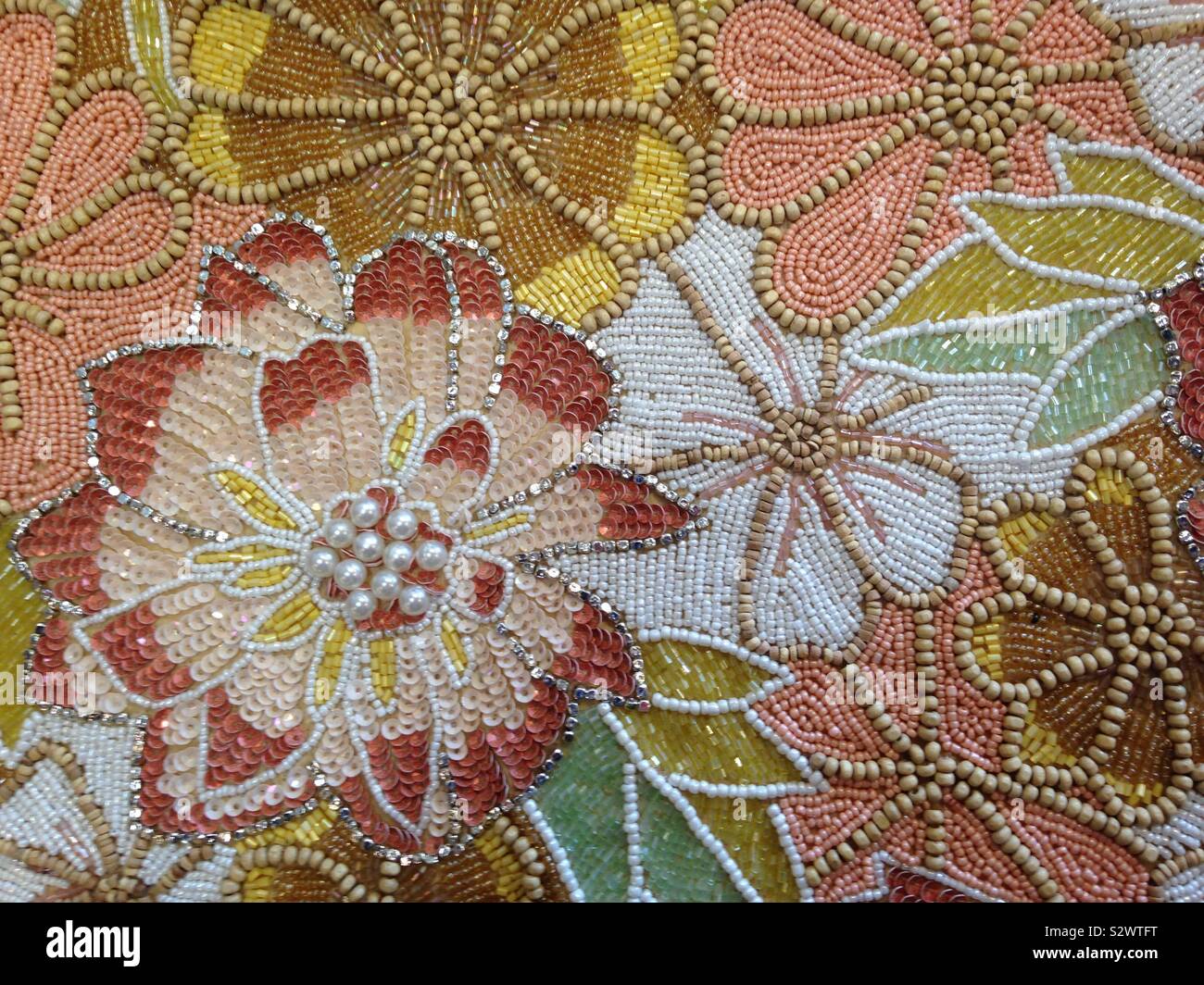 Beaded floral motif using earth-tone colors. Stock Photo