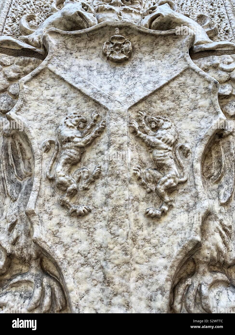 Marble carving of a crest with two lion griffins snarling at each other. Stock Photo