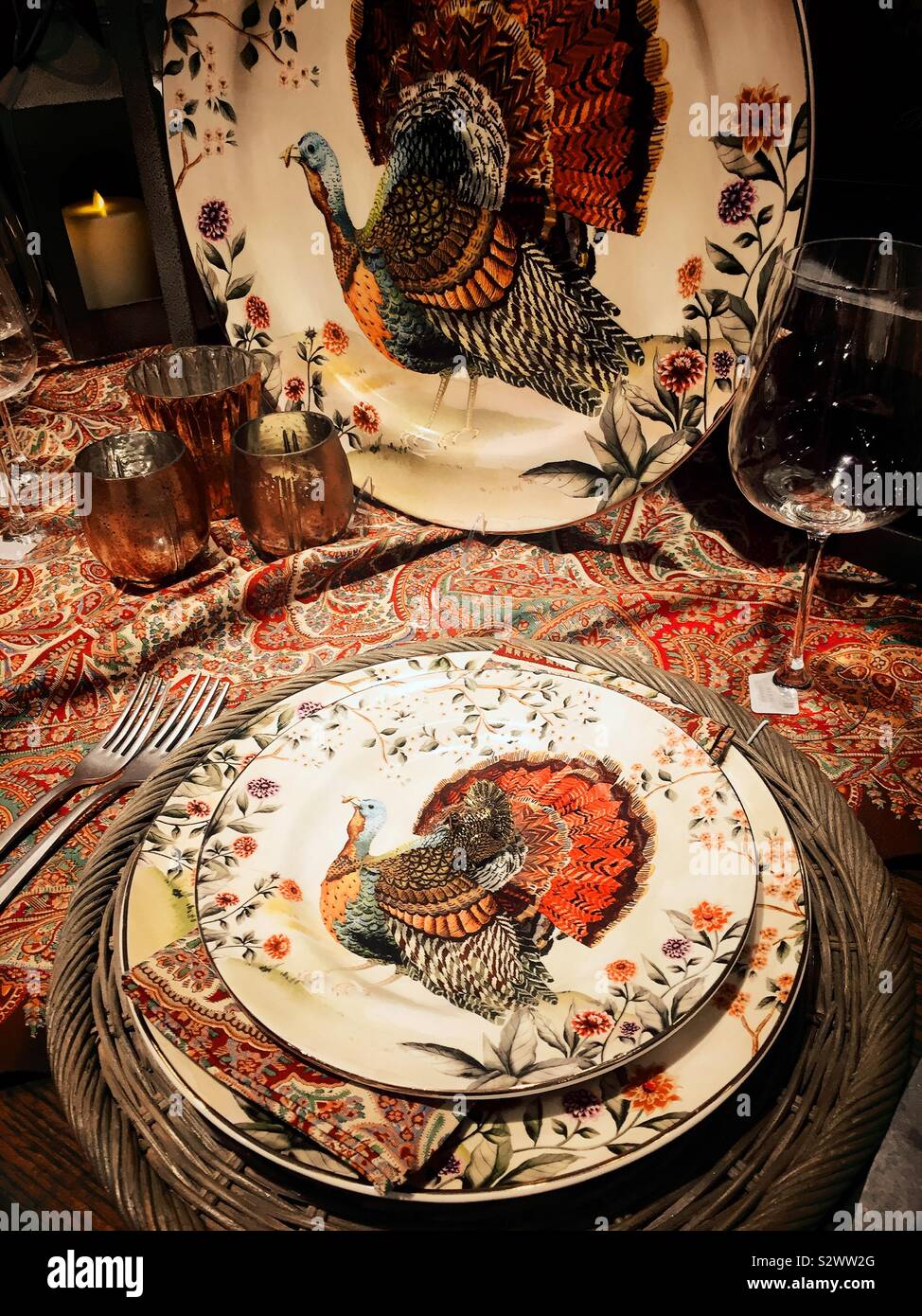 Table setting for a traditional Thanksgiving meal featuring plates and platters with a turkey , United States - Smartphone Captured Stock Image