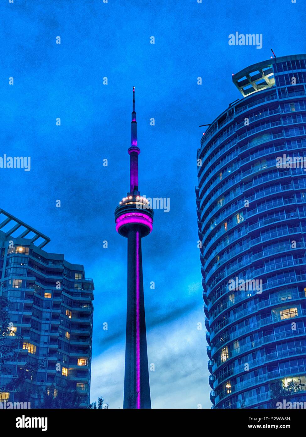 The CN Tower illuminated at dusk Stock Photo - Alamy