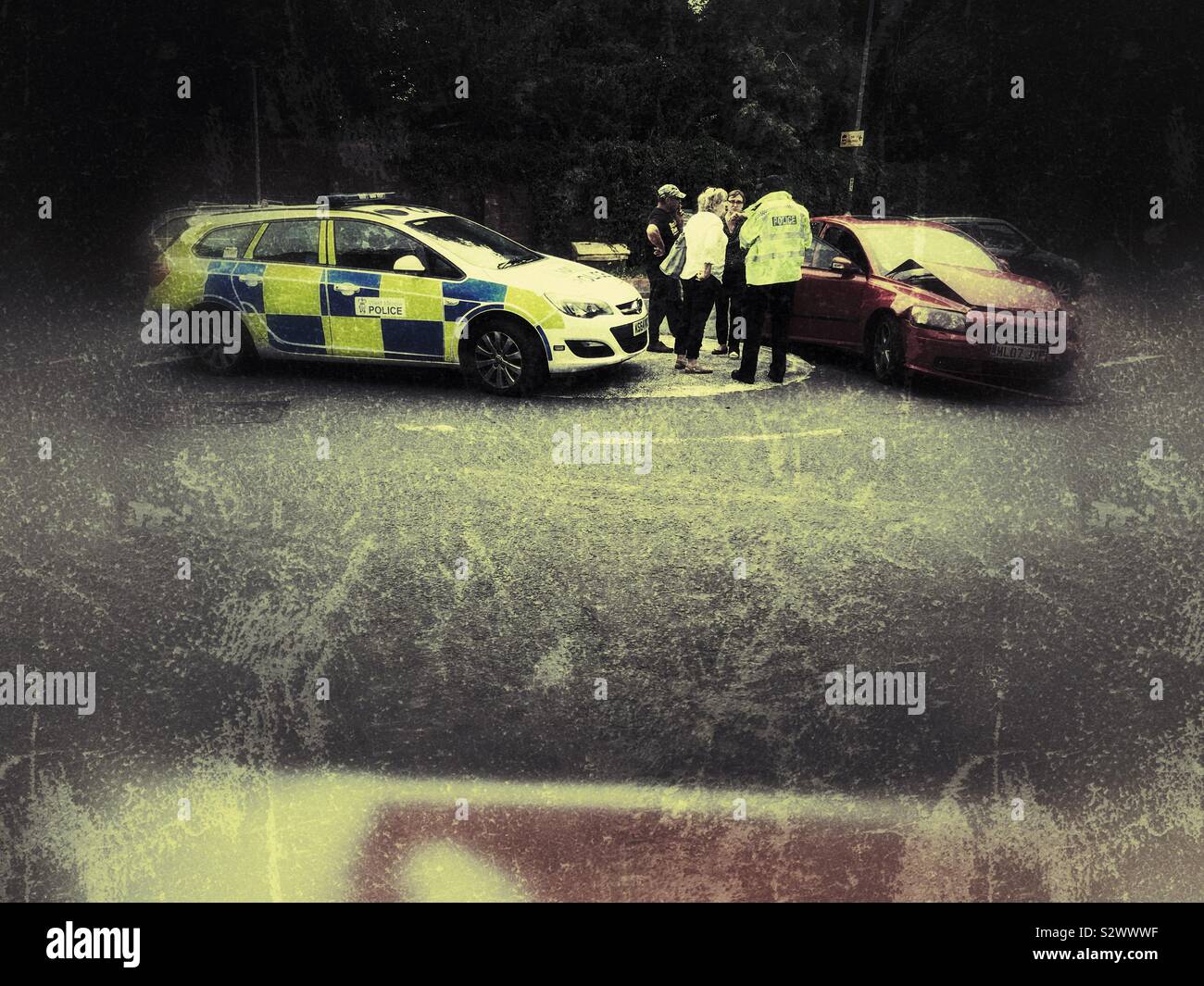Police attend a car accident on a mini roundabout in UK 2019 - Smartphone Captured Stock Image