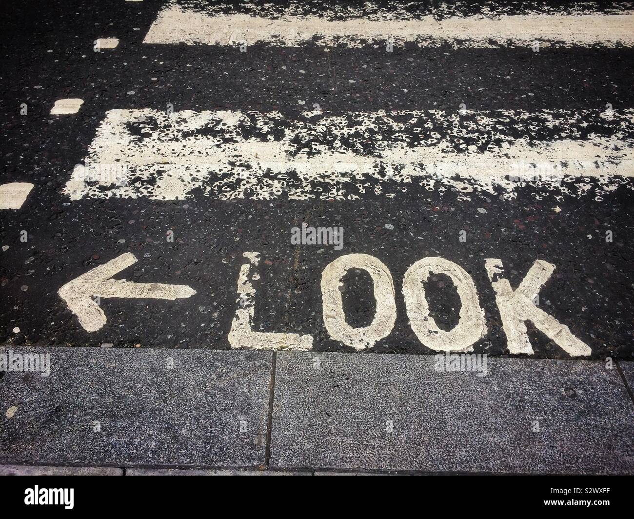 Look left sign on road in London, UK - Smartphone Captured Stock Image
