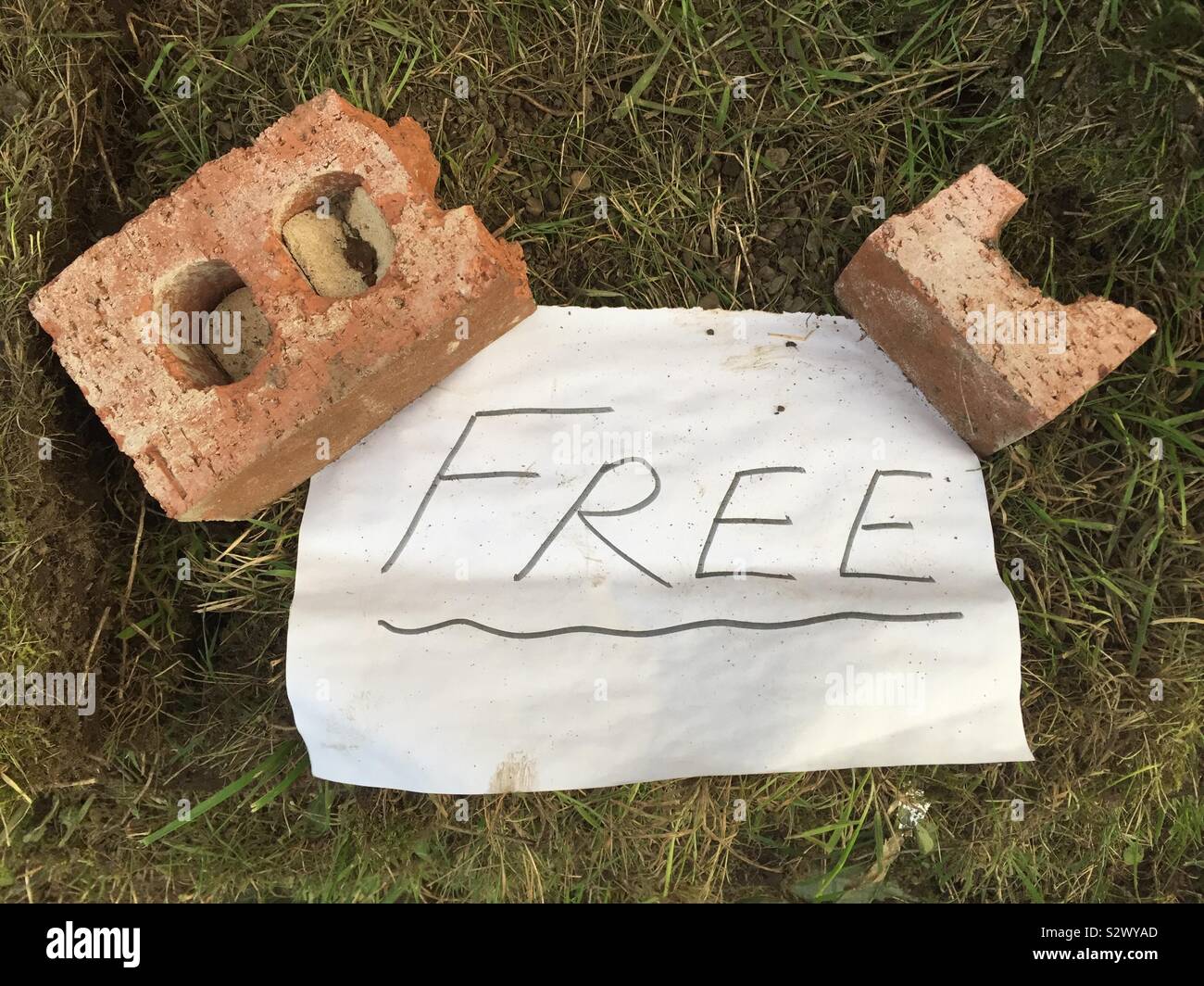 Homemade Free sign weighed down by bricks - Smartphone Captured Stock Image