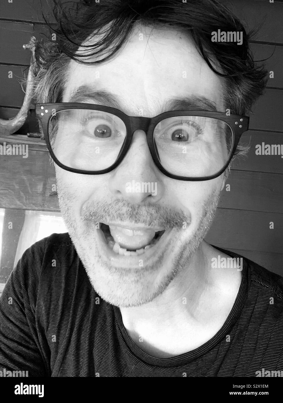 Very happy guy with glasses in black and white - Smartphone Captured Stock Image