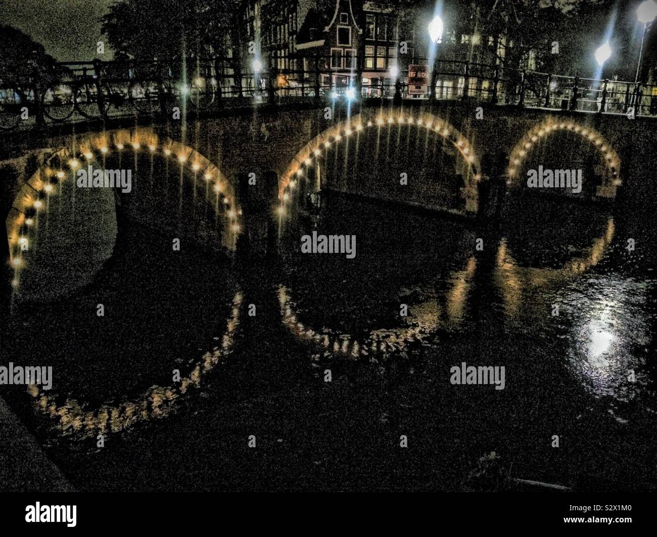 Illuminated Canal Bridge In Amsterdam - Smartphone Captured Stock Image