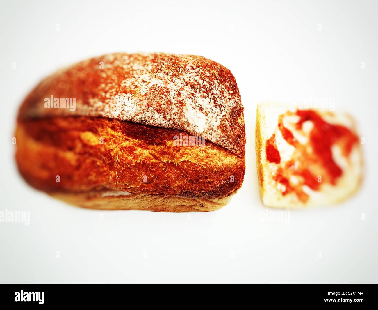 Homemade bread with slice covered in strawberry jam - Smartphone Captured Stock Image