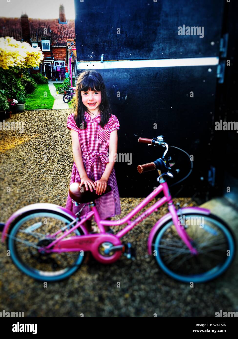 7-year old girl with a new bicycle for her birthday Stock Photo