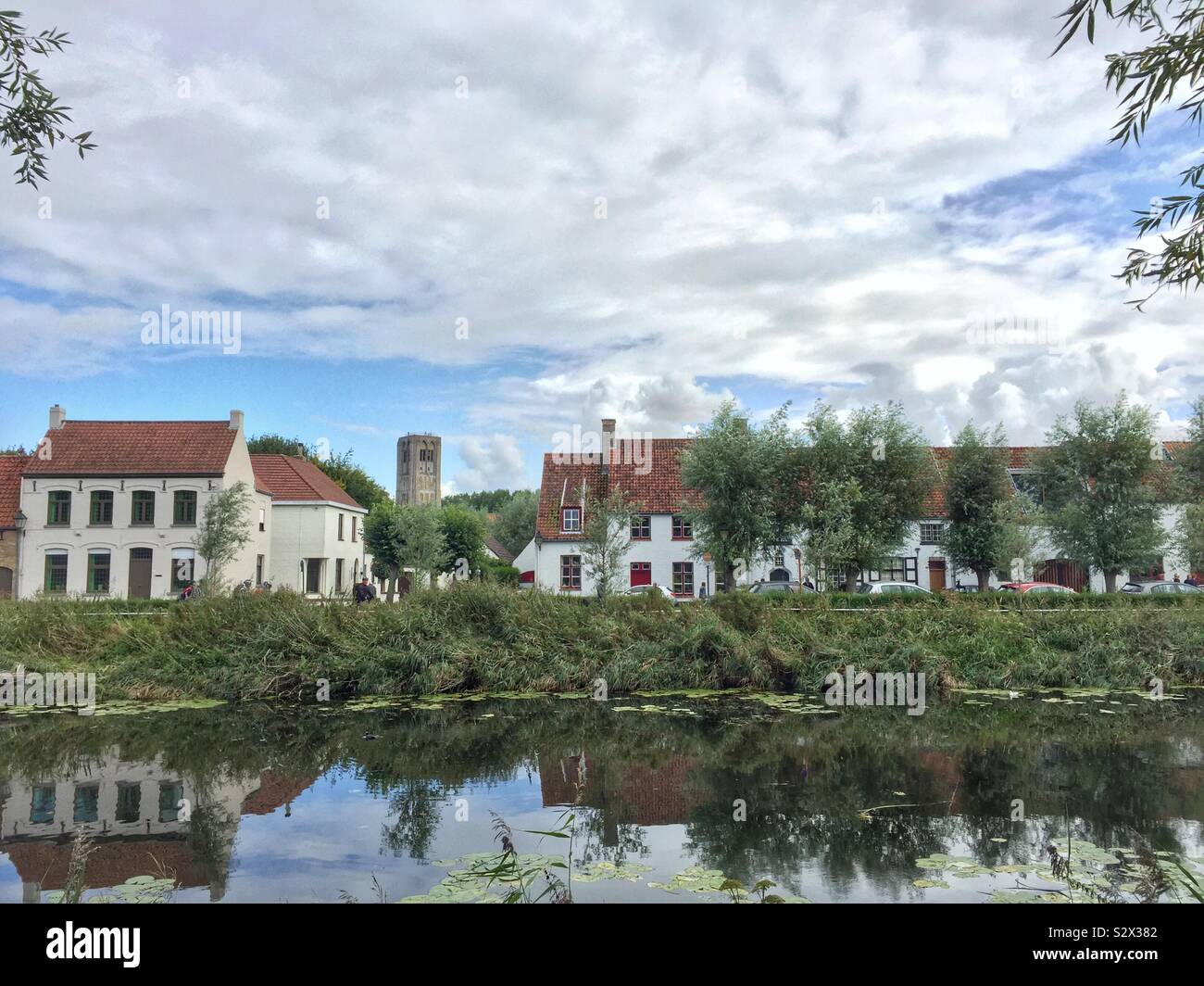 View of a row of houses from the river in Damme, near Bruges, Belgium - Smartphone Captured Stock Image