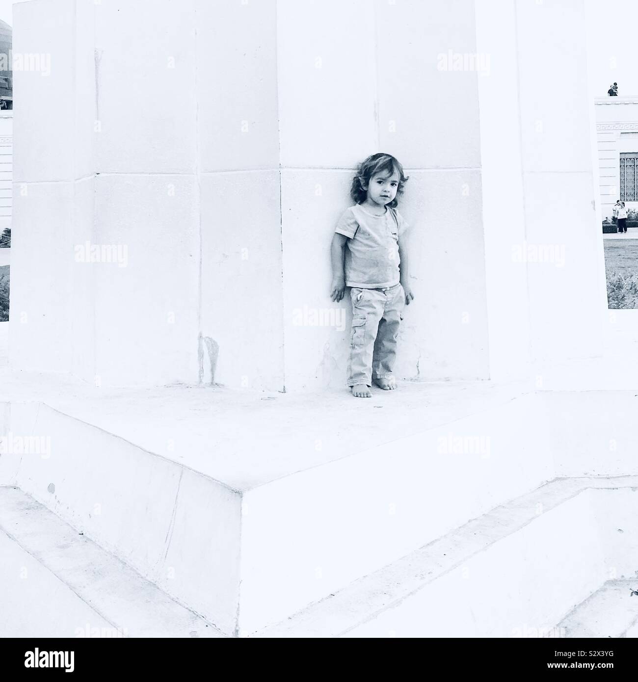 Kid standing against wall Stock Photo - Alamy