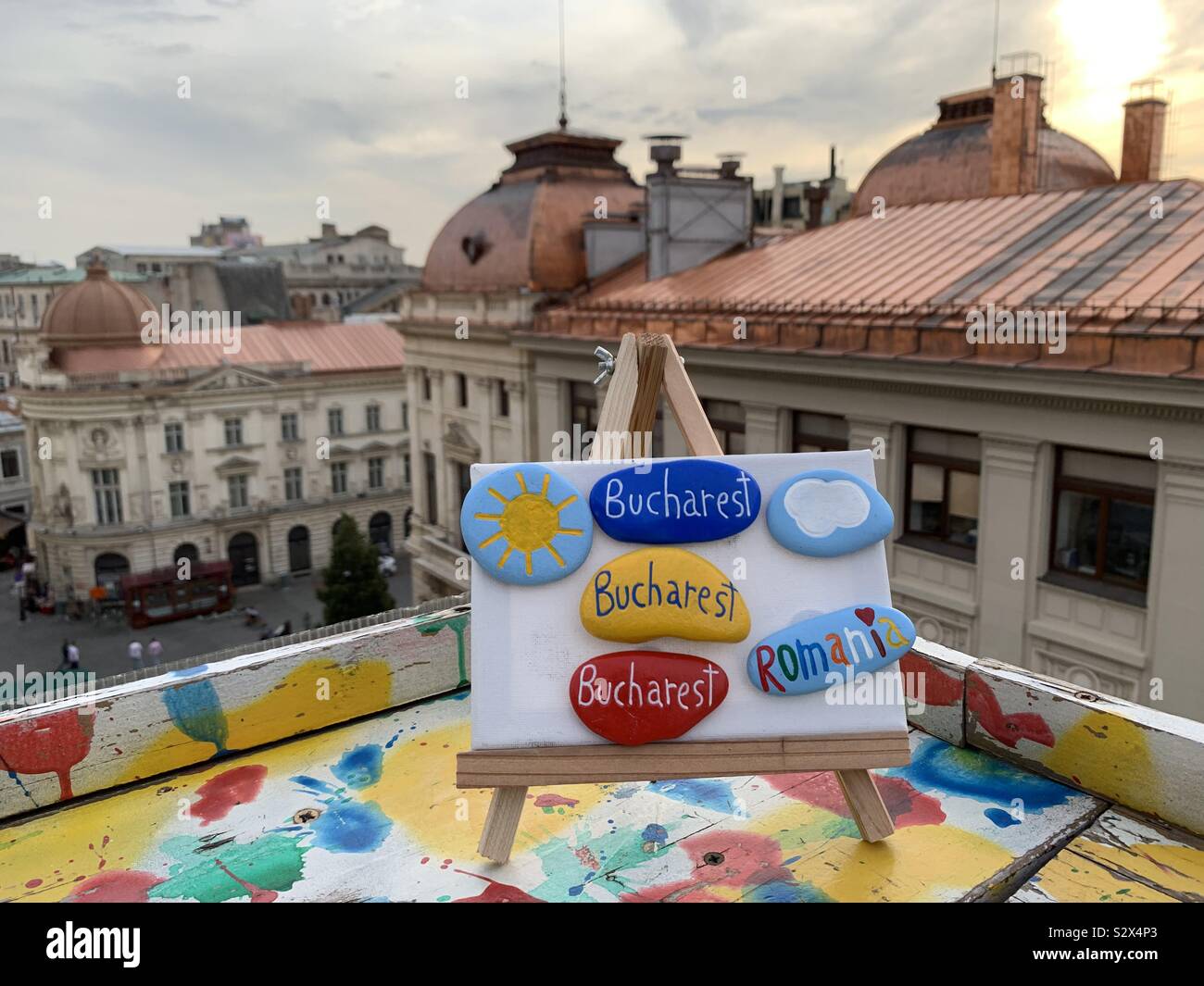 Souvenir of Bucharest with colored stones with cityscape background - Smartphone Captured Stock Image