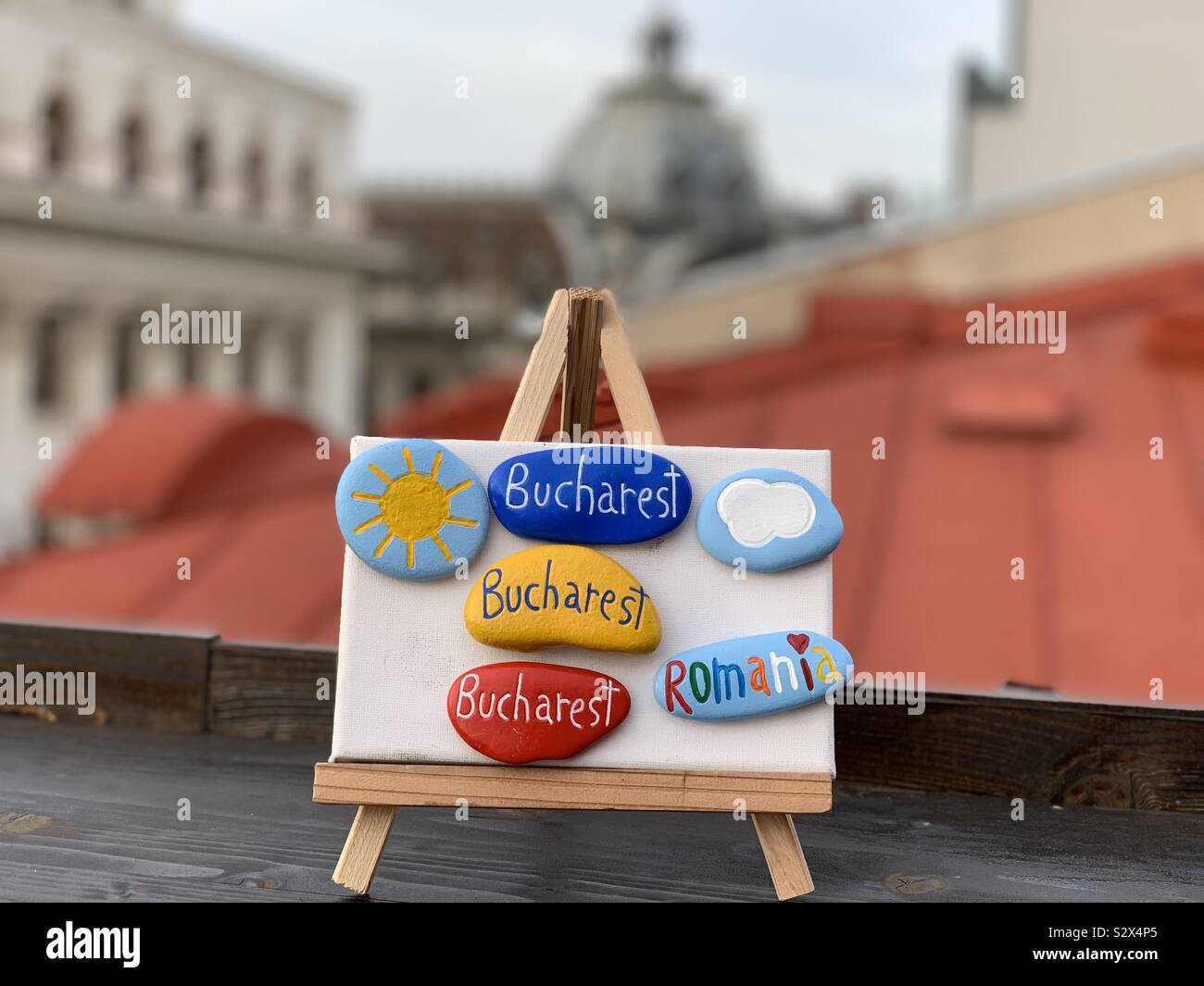 Visit Bucharest, creative poster design with a coposition of painted stones over a canvas Stock Photo