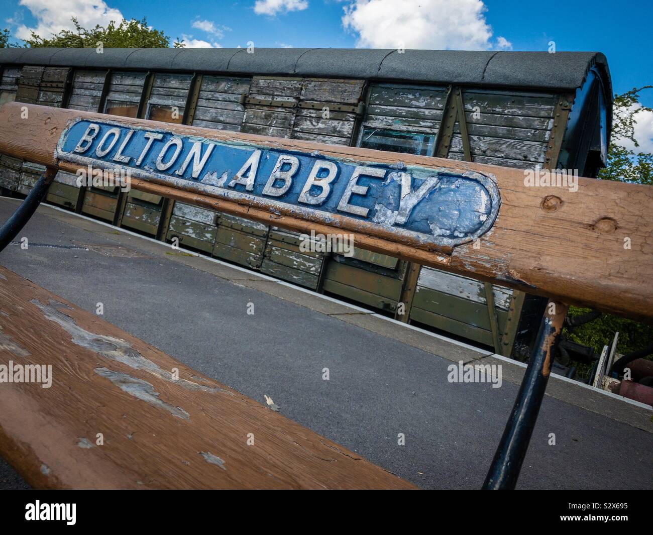 Bolton Abbey sign on bench at railway station in Yorkshire Stock Photo