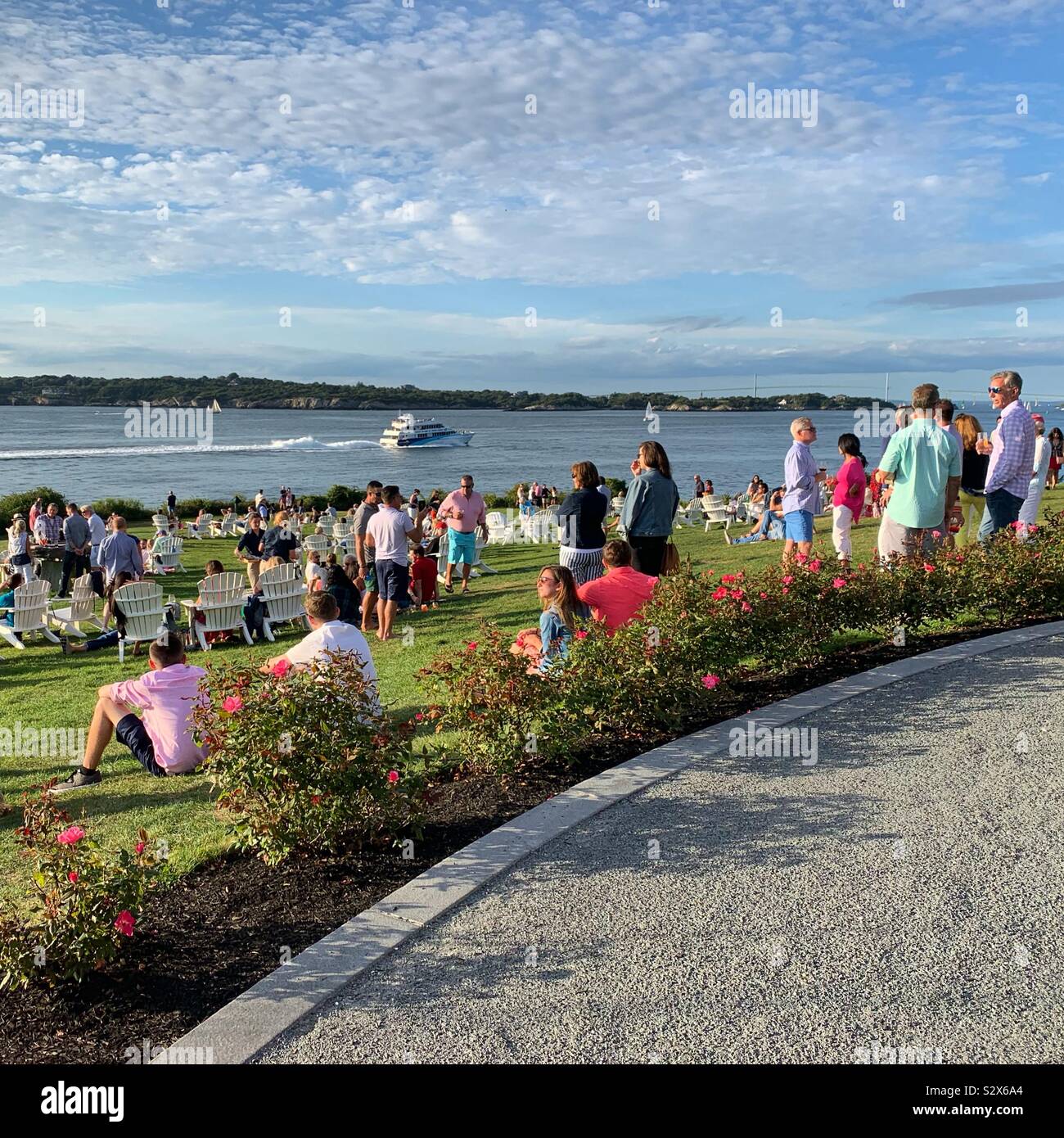 People gathering on the lawn in the late afternoon at Castle Hill Inn, Newport, Rhode Island, United States - Smartphone Captured Stock Image