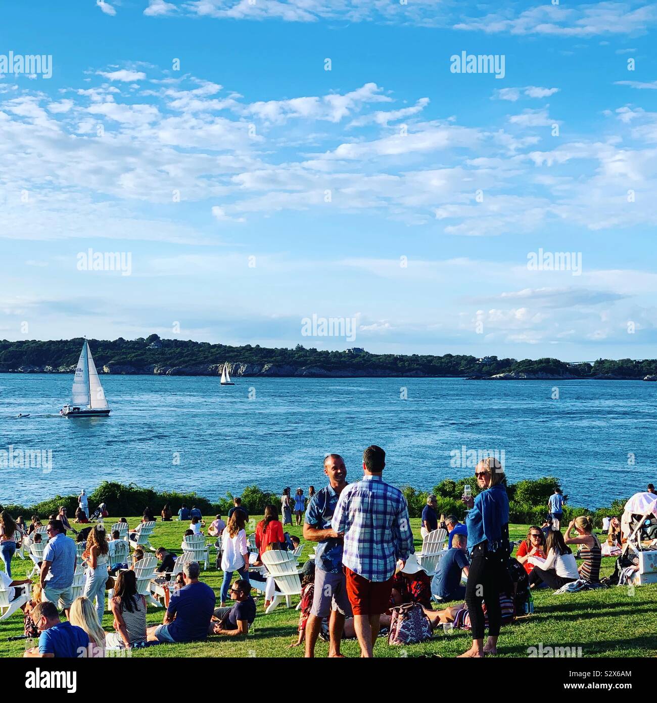 Guests gathering on the lawn in the late afternoon at Castle Hill Inn, Newport, Rhode Island, United States - Smartphone Captured Stock Image