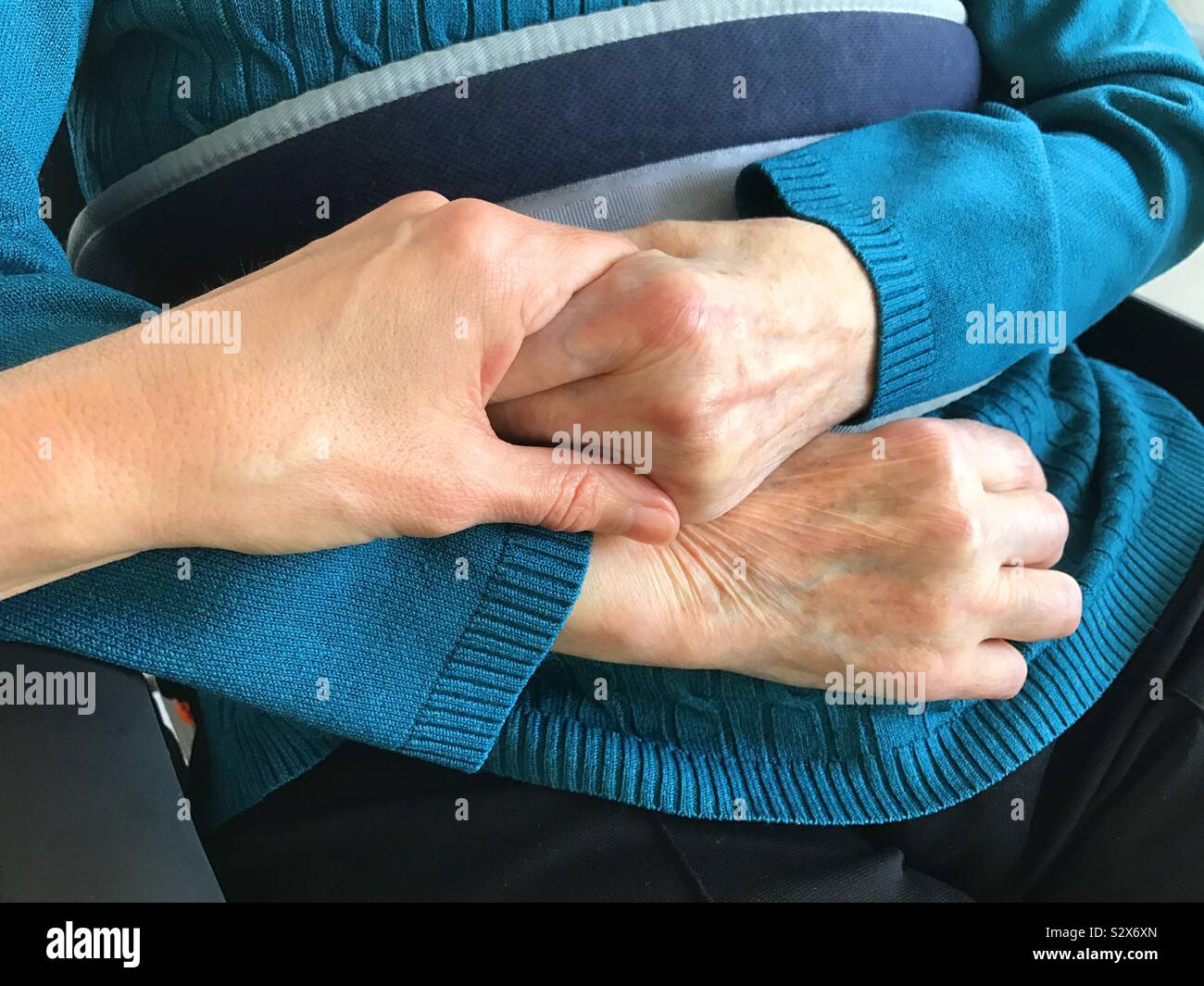 Hand holding an old lady's hand - Smartphone Captured Stock Image