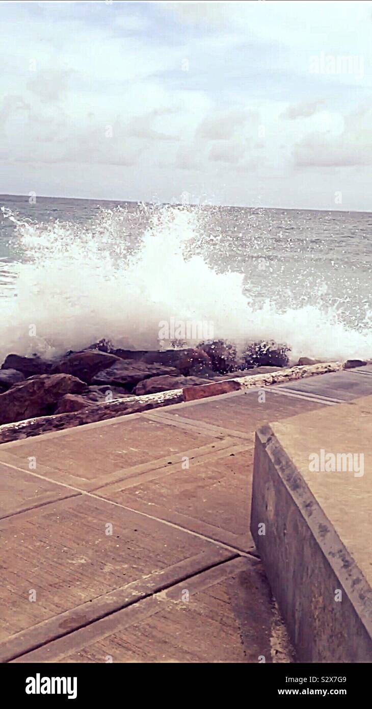 Waves crashing onto shore in Barbados Stock Photo