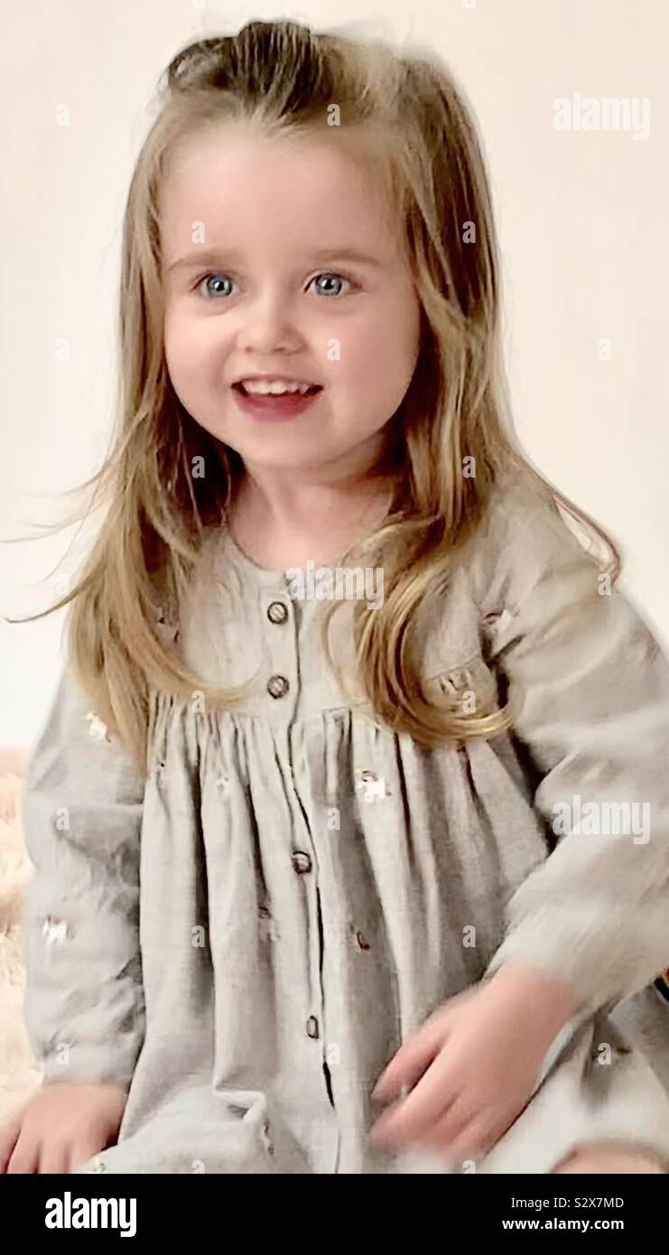 Nearly 3 year old little girl”Mae” with cute smile and long hair Stock Photo
