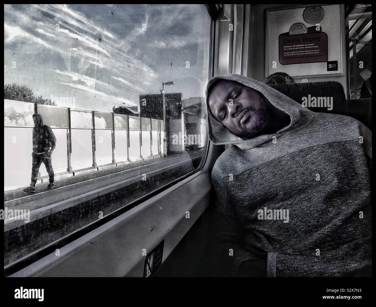 A weary commuter sleeps on the train. - Smartphone Captured Stock Image