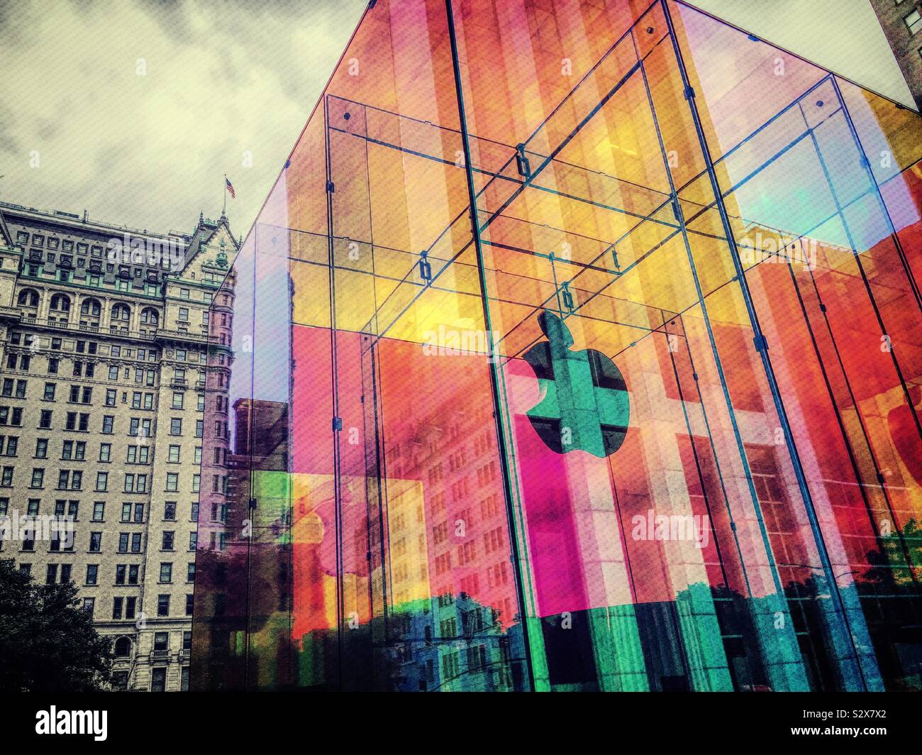 The iconic Apple store cube wrapped in iridescent colors is located across from the famous plaza hotel, United States, NYC - Smartphone Captured Stock Image