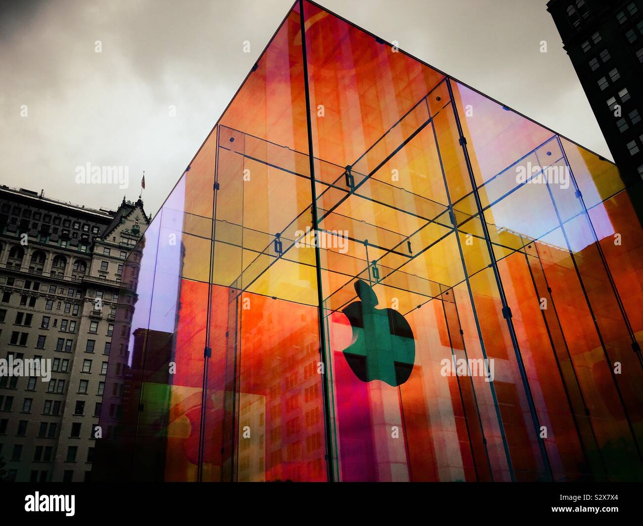 The iconic Apple store glass cube is located across from the famous plaza hotel in wrapped in a temporary iridescent wrap, NYC, USA - Smartphone Captured Stock Image