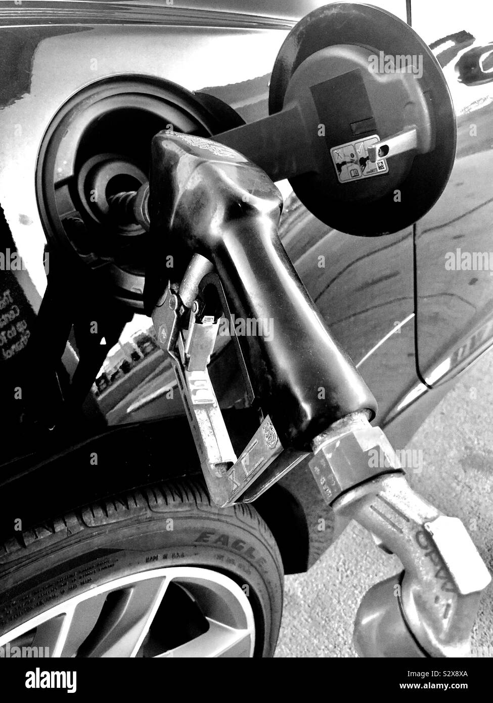 Gasoline pump fill-up nozzle black and white Stock Photo