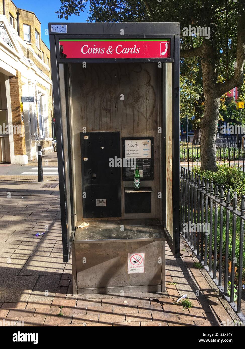 A damaged phone box in Lewisham London, England September 2019 - Smartphone Captured Stock Image