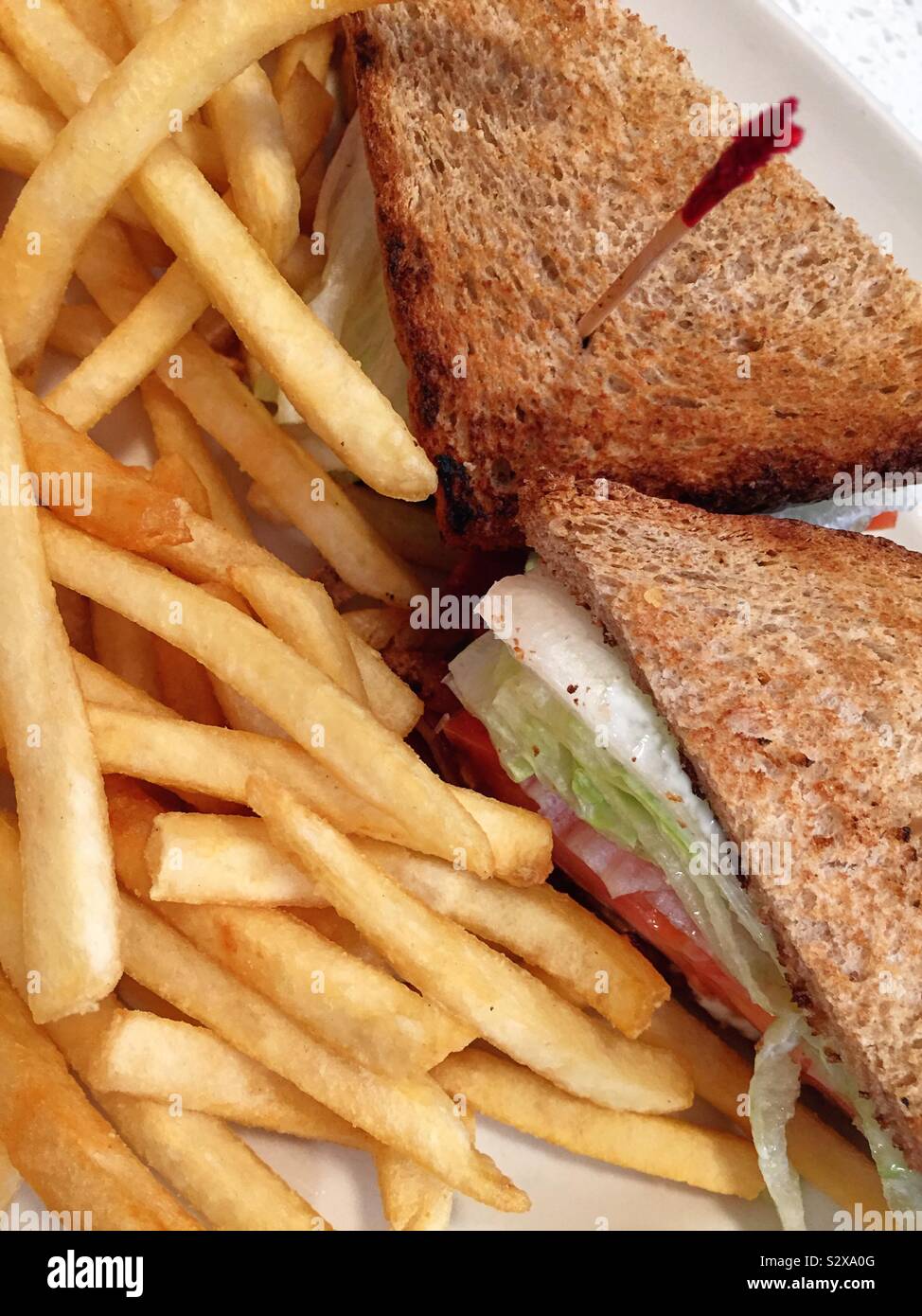 Flat lay close up of bacon lettuce and tomato sandwich and french fries at an all American diner, USA - Smartphone Captured Stock Image