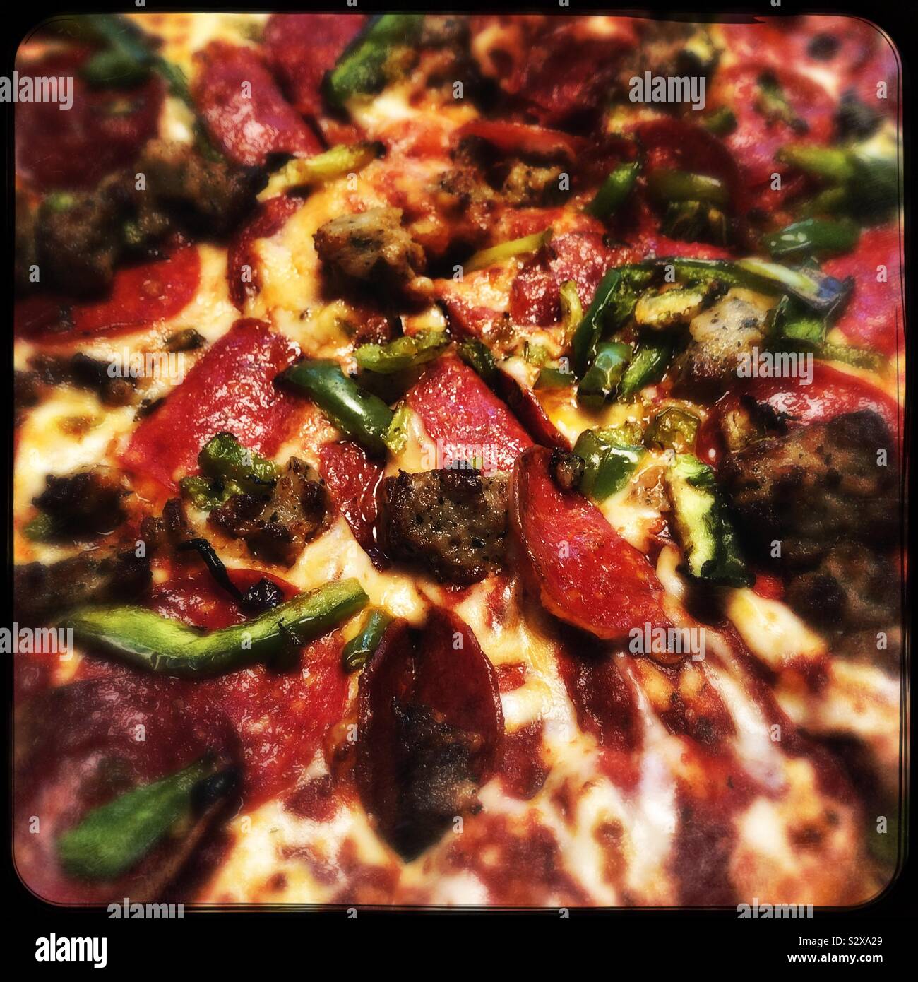 Closeup of pepperoni sausage & green pepper pizza Stock Photo