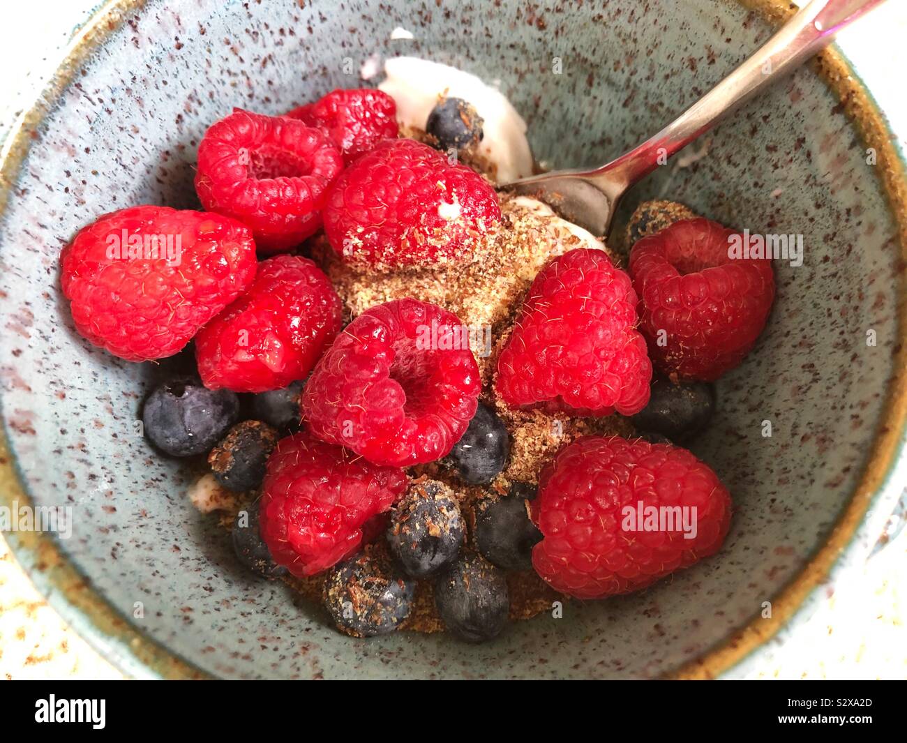 Yogurt with ground flax seed and berries in a bowl Stock Photo Alamy