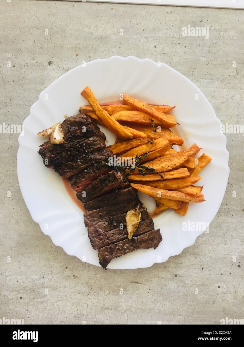 Steak with sweet potato fries Stock Photo - Alamy