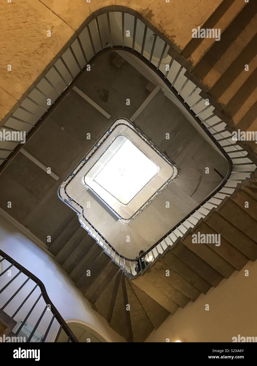 An winding stairwell viewed from below. Stock Photo