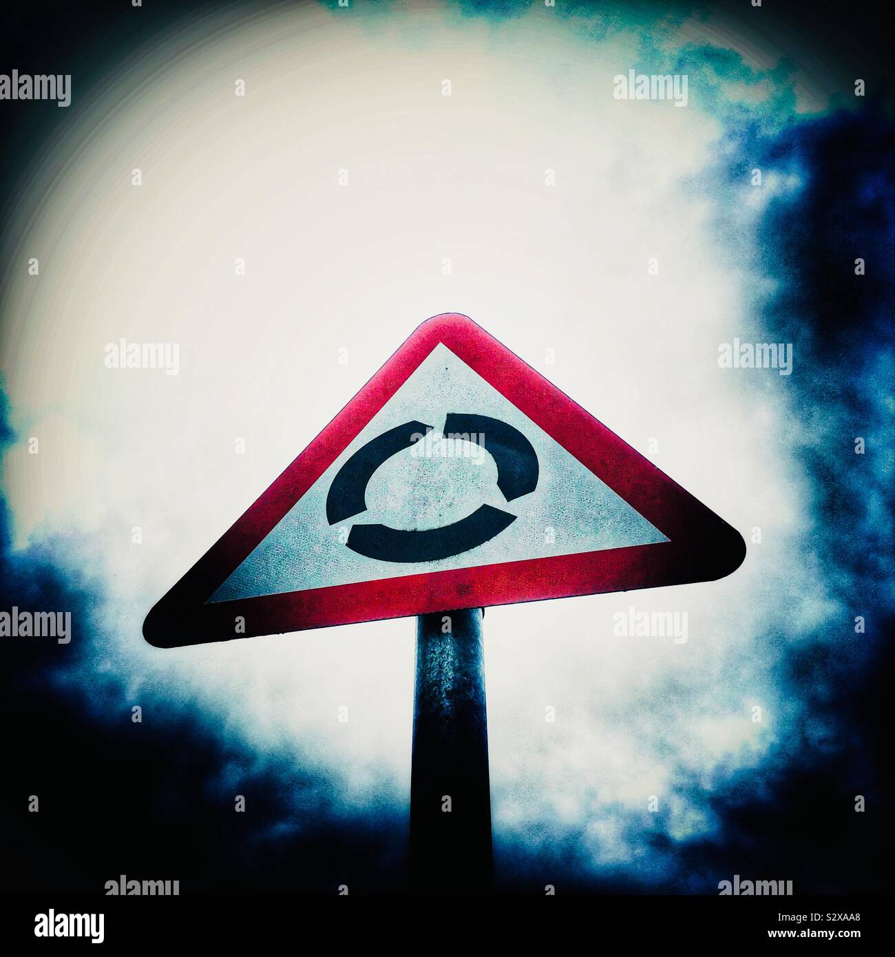 Roundabout traffic sign isolated against sky - Smartphone Captured Stock Image