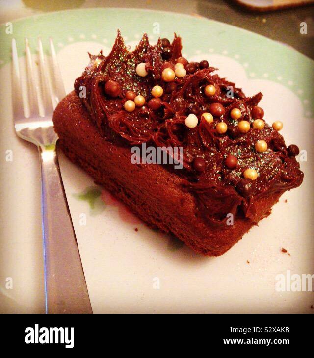 Homemade chocolate cake with chocolate balls and iridescent glitter. Stock Photo