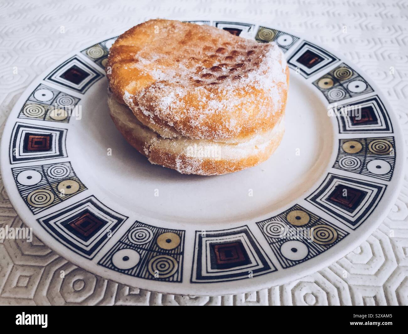 Jam doughnut on a saucer. - Smartphone Captured Stock Image