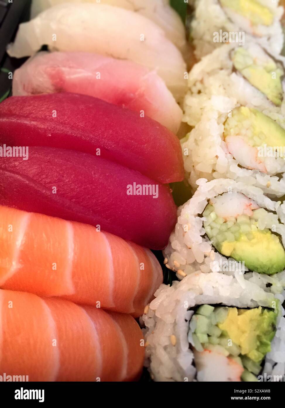 Close up of sushi pieces and a California roll in an entrée from a Japanese restaurant, USA - Smartphone Captured Stock Image