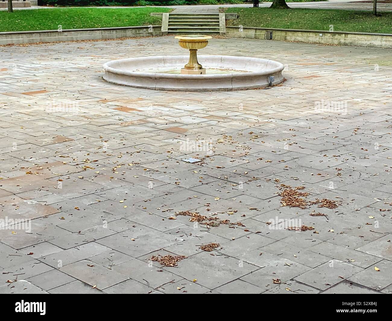 Huge empty and plaza with a dry water fountain in the middle. Stock Photo