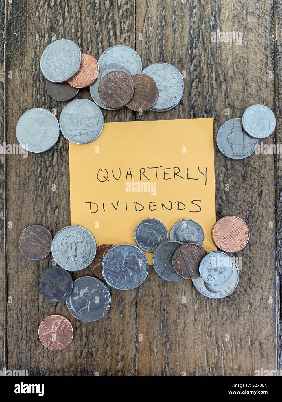 Quarterly dividends from stock in U.S. coins Stock Photo