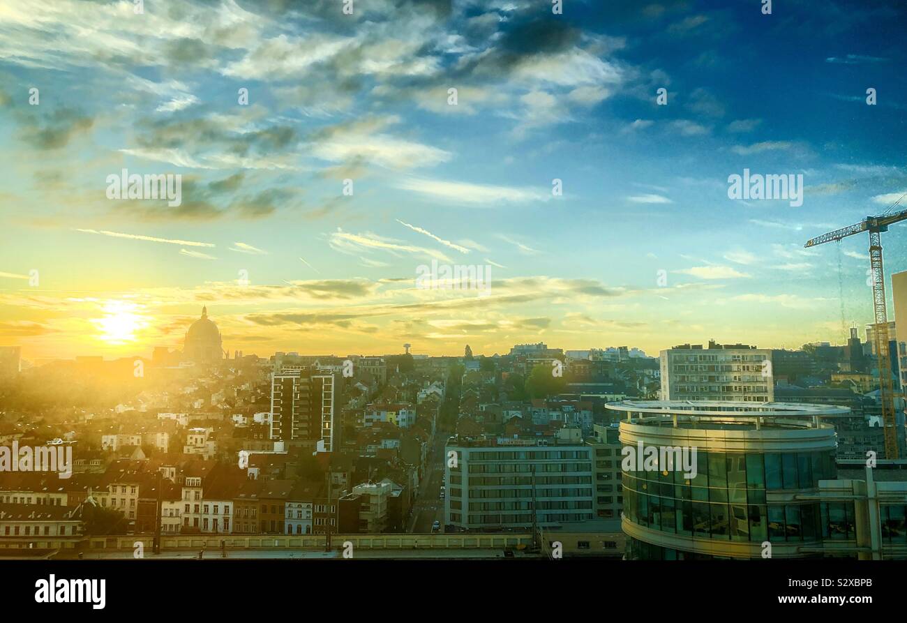 Colorful Golden and blue sky during sunrise over the city of Brussels around the North railway station - Smartphone Captured Stock Image