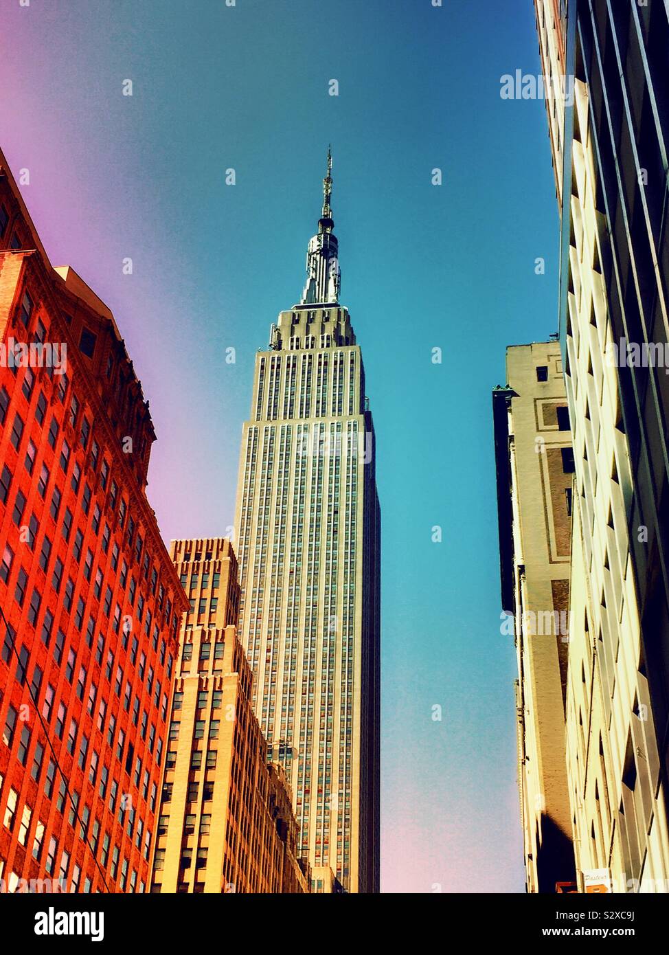 The Empire State building is an iconic tourist attraction at the intersection of fifth Avenue and 34th St. in midtown Manhattan, NYC, USA - Smartphone Captured Stock Image