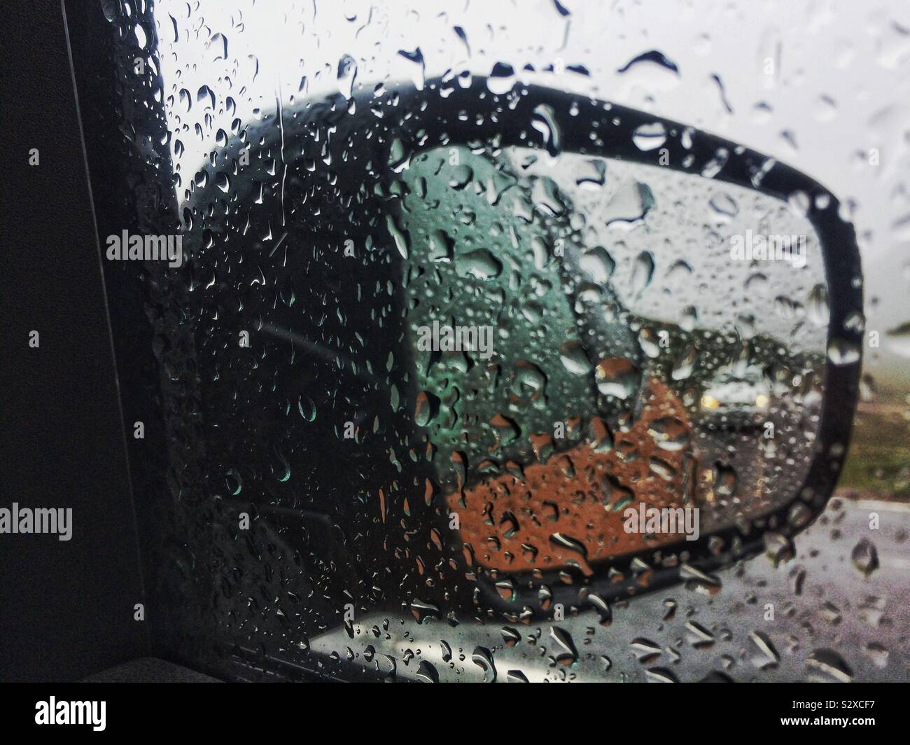 Water drops on car side mirror - Smartphone Captured Stock Image