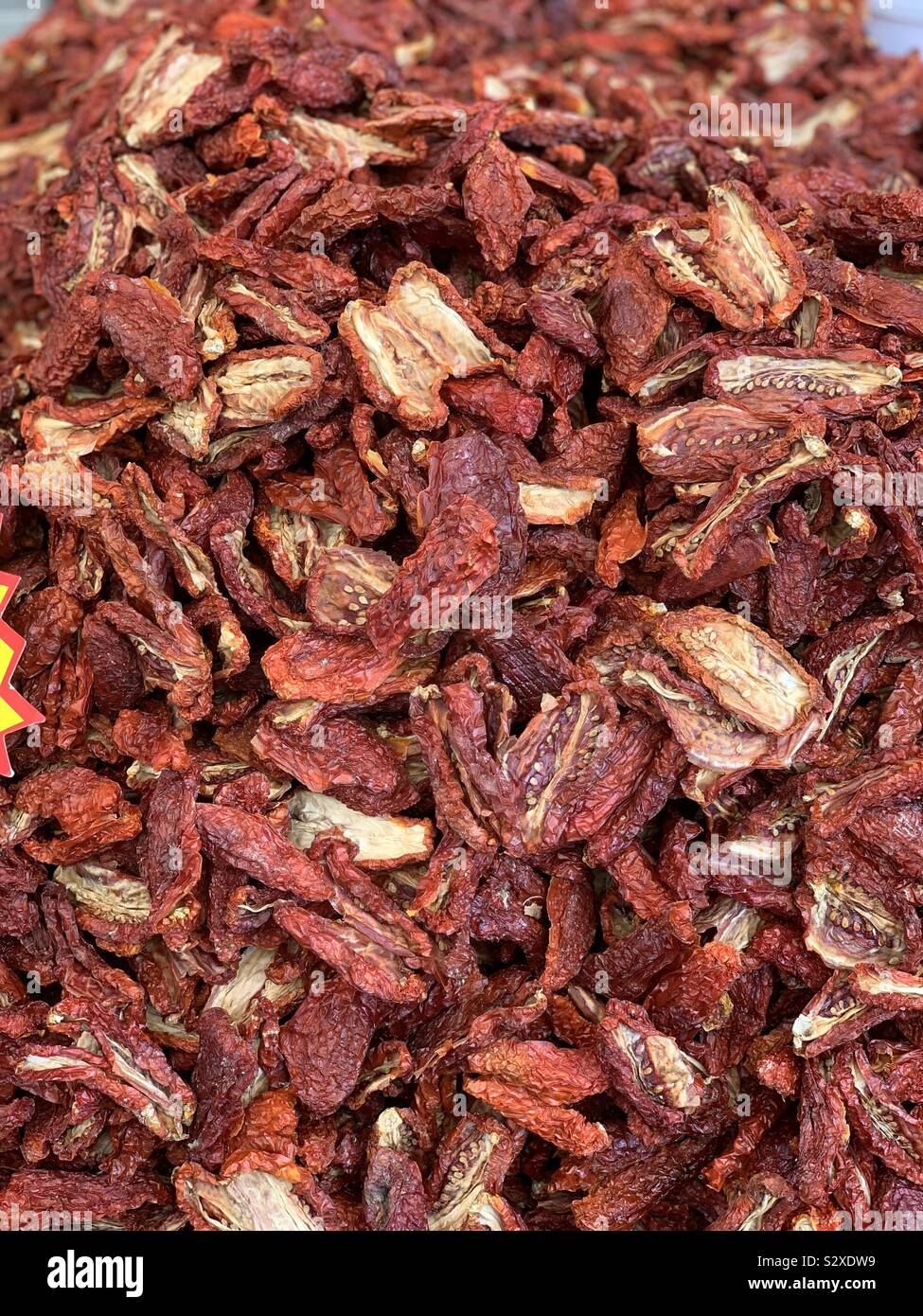 Sun dried tomatoes at a vegetables market of Catania, Sicily, Italy - Smartphone Captured Stock Image