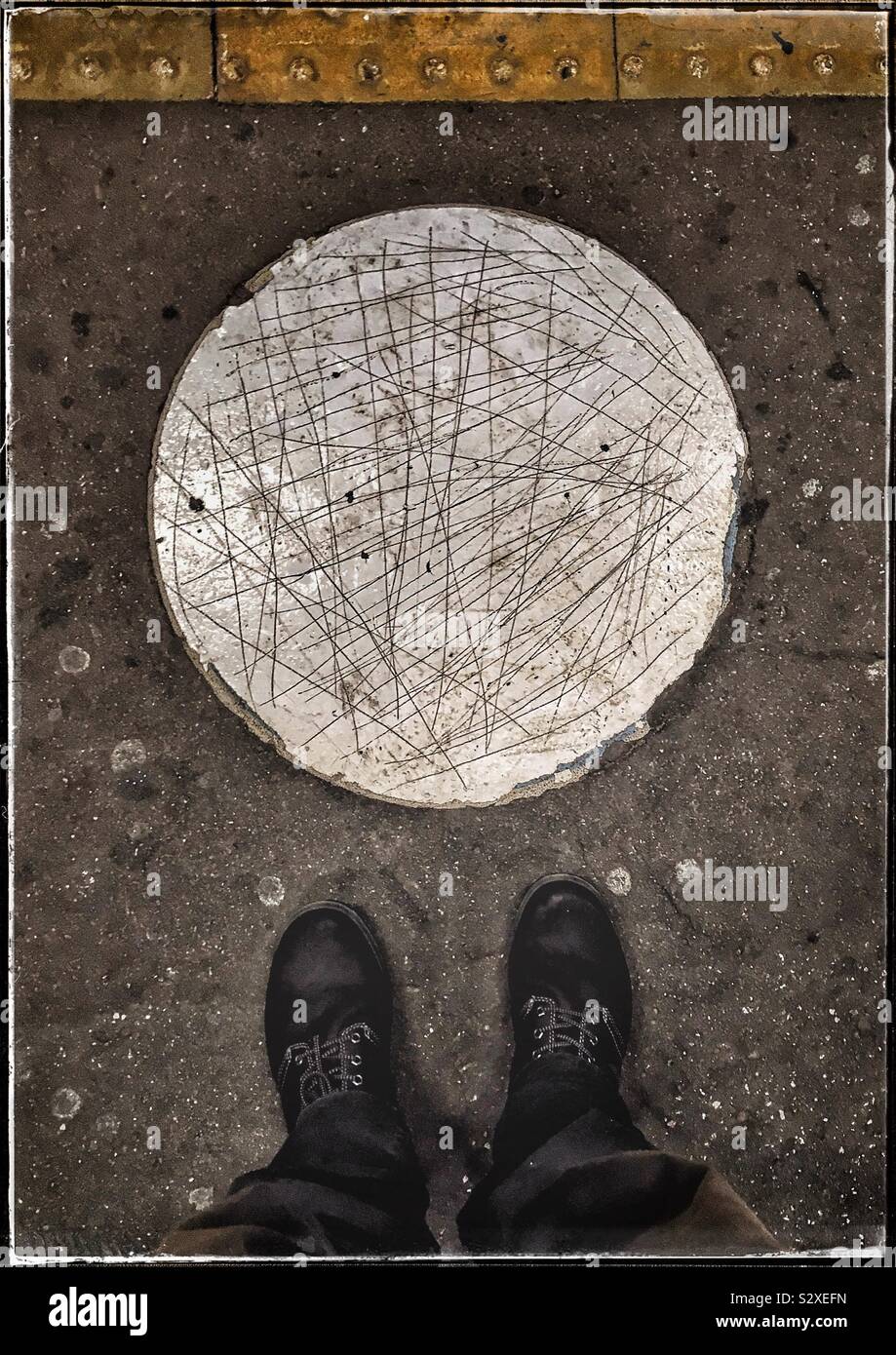 Scratched painted circle on platform floor of Wembley Park Tube train station - Smartphone Captured Stock Image