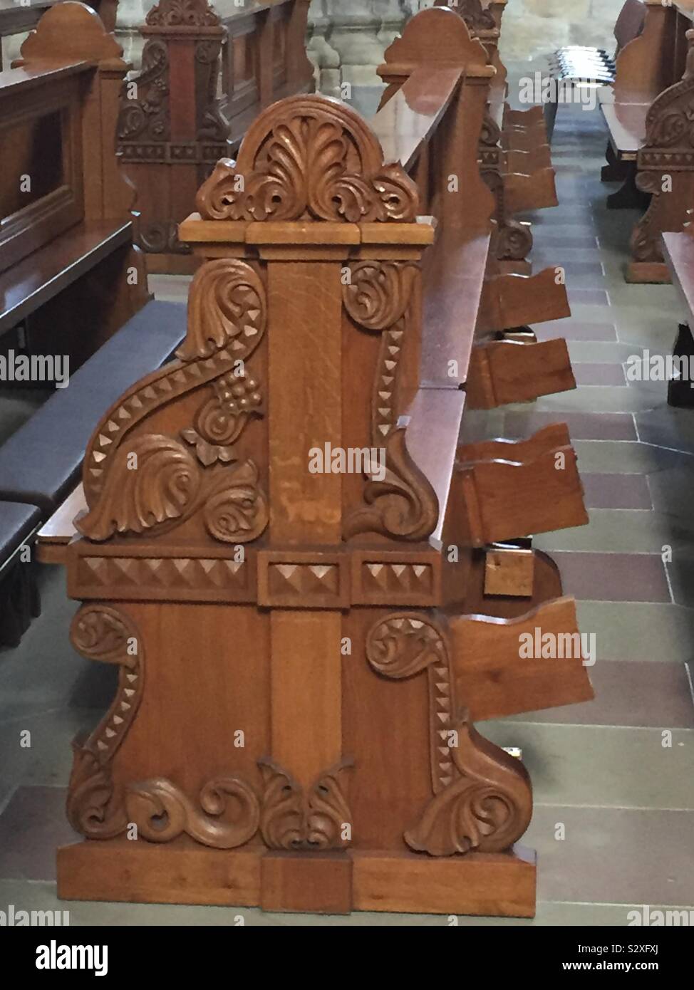 Church pew in wood with carvings Stock Photo