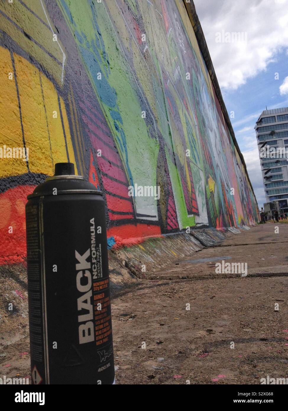 Spray paint can left beside a graffitied section of the old Berlin Wall