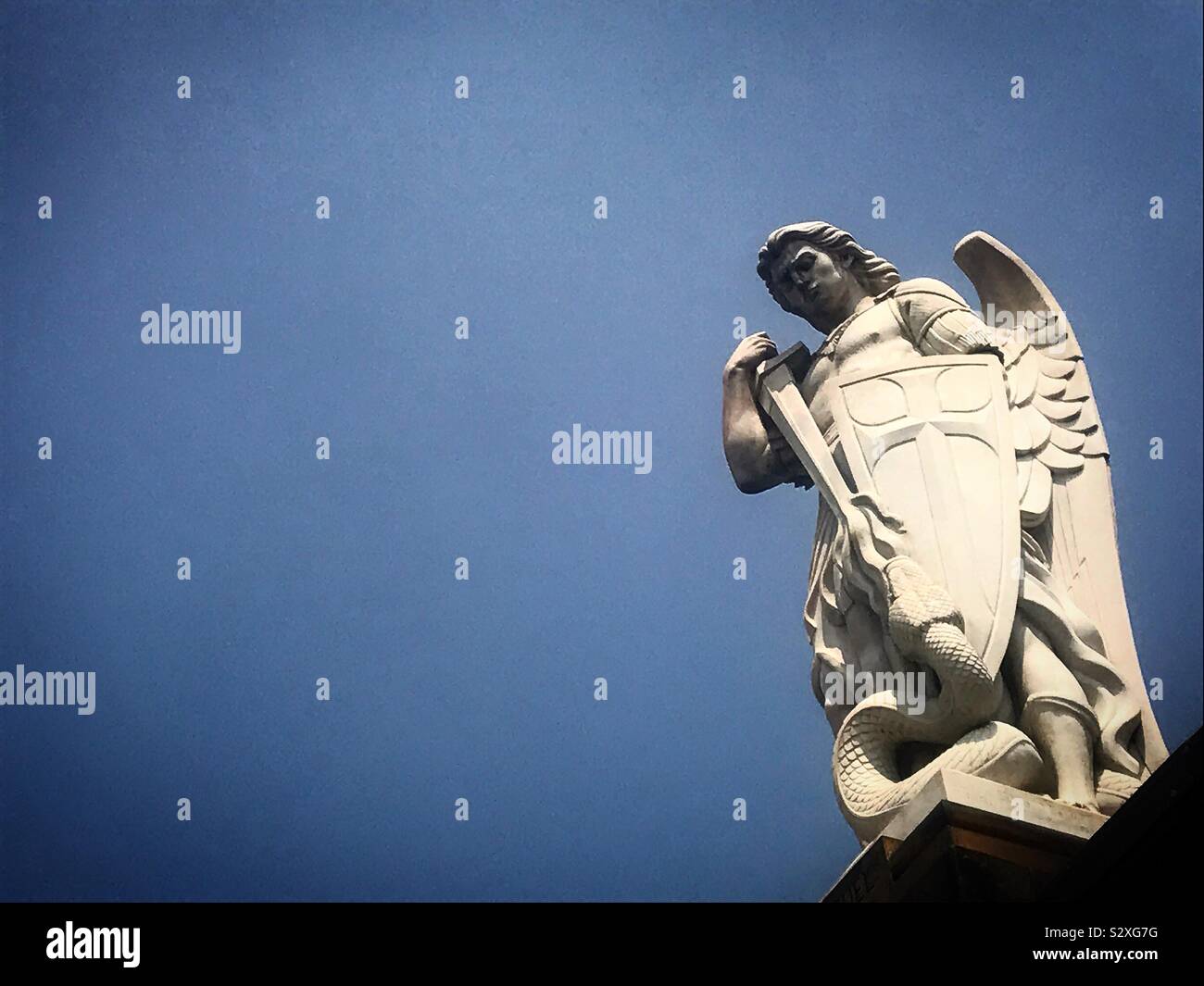 A sculpture of Saint Michael Arcangel killing Satan with his sword decorates the Basilica of Our Lady of Guadalupe in Mexico City, Mexico - Smartphone Captured Stock Image