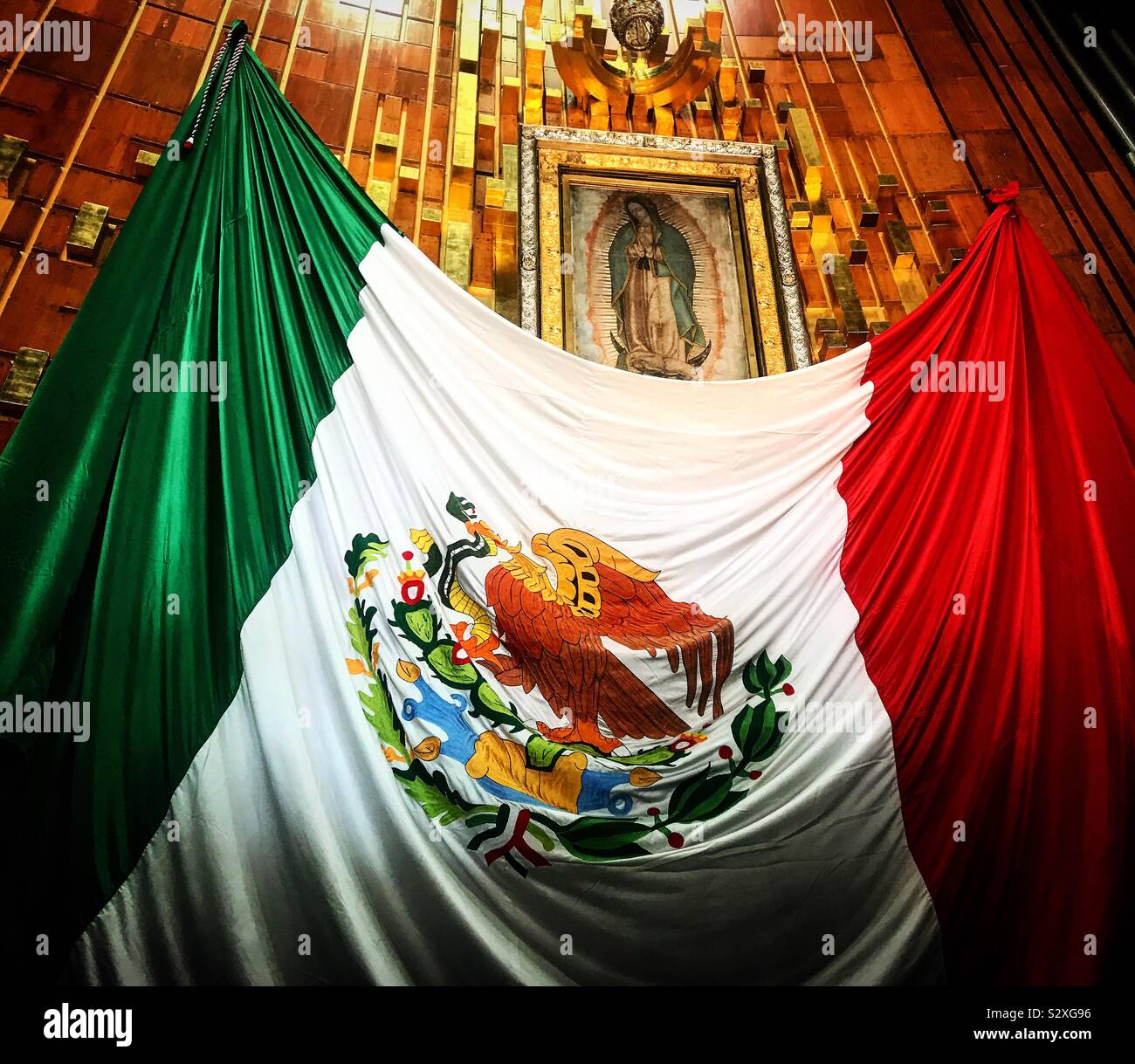 The Mexican flag decorates the altar of Our Lady of Guadalupe in Mexico City, Mexico. Stock Photo