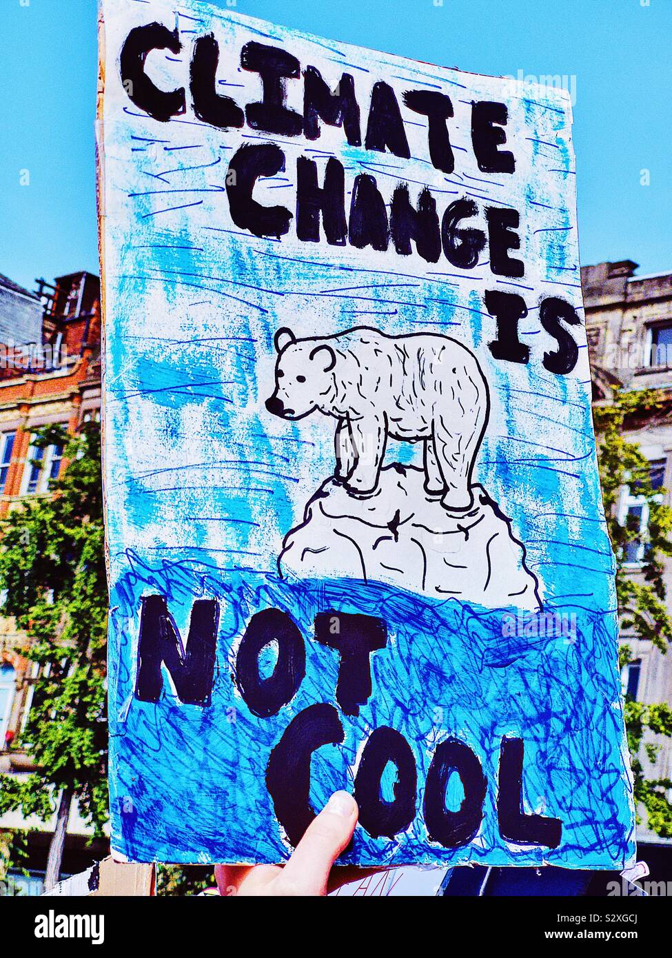 Polar bear standing on melting ice block on placard at the 20th September global climate strike, Nottingham, Nottinghamshire, East Midlands, England - Smartphone Captured Stock Image