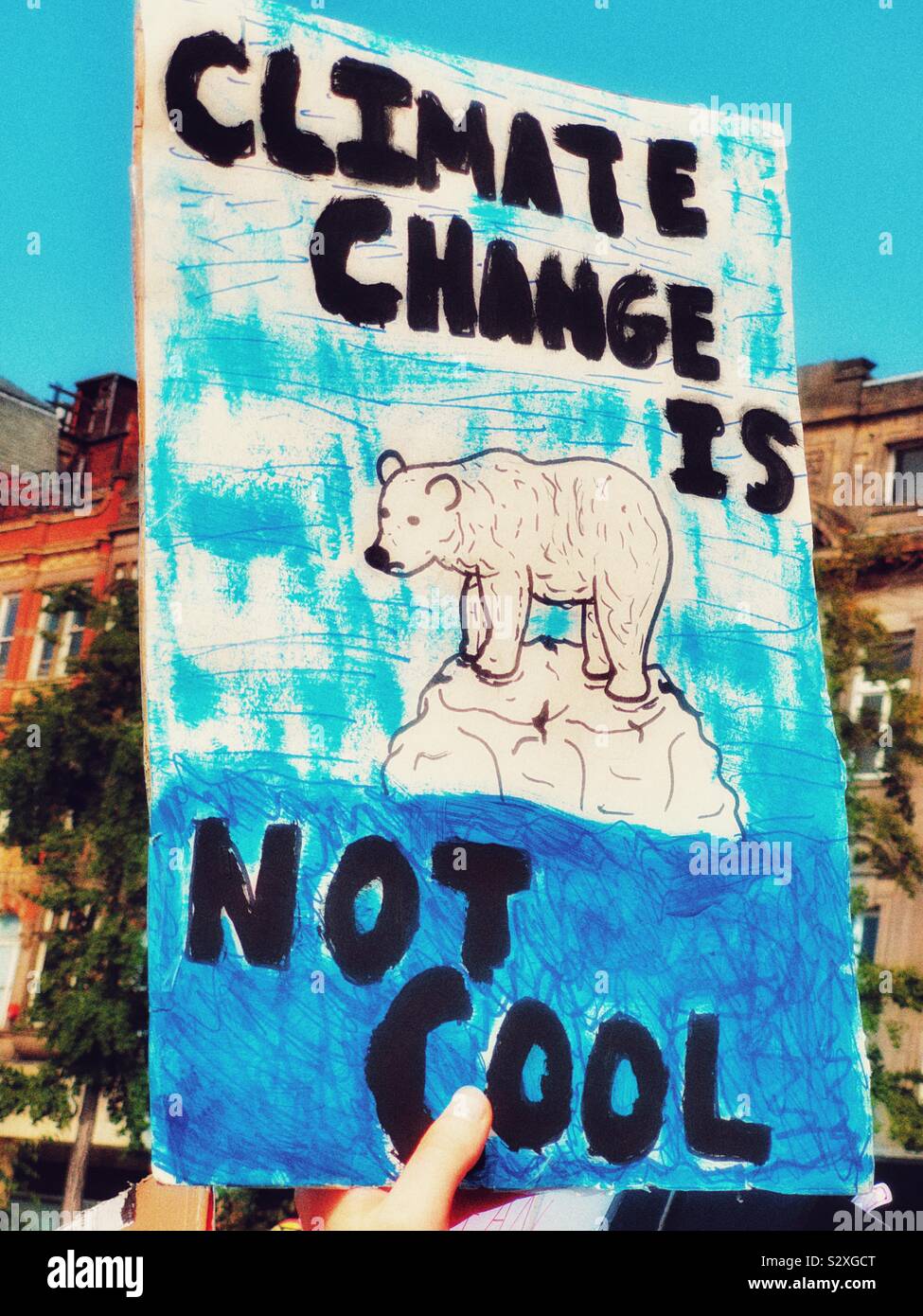 Polar bear standing on melting ice block on placard at the 20th September global climate strike, Nottingham, Nottinghamshire, East Midlands, England Stock Photo